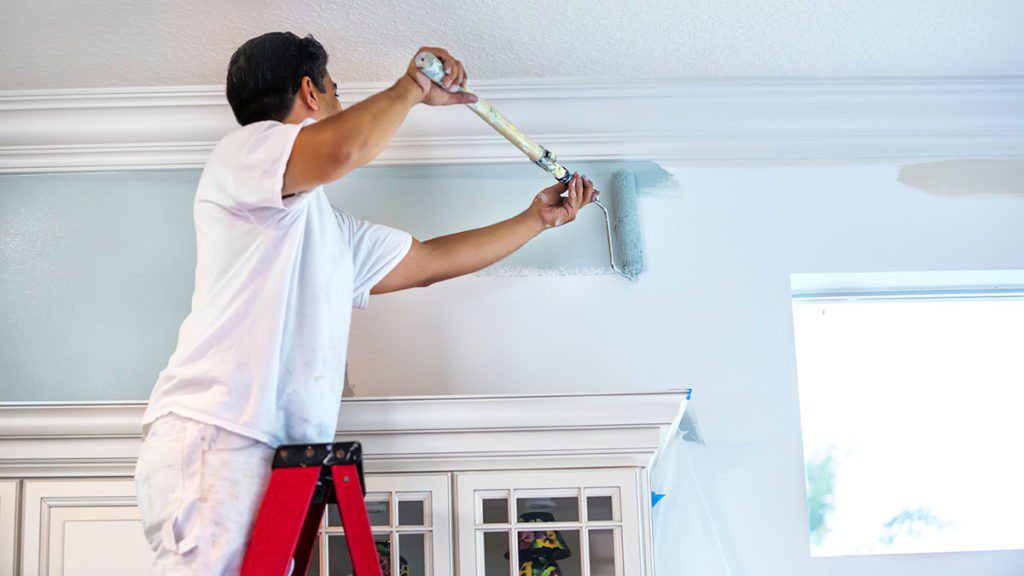 Professional painter applying a fresh coat of interior paint
